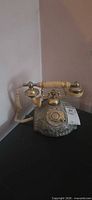 Full view of ornate metal rotary telephone