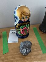 Nesting doll and Wolf Originals sculpture on shelf