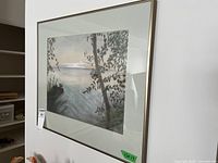 Front view of framed charcoal landscape drawing on wall
