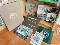 Lot overview showing multiple Kingston history titles and American Atlas