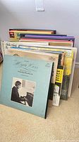 Stack of classical vinyl record albums standing on floor
