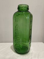 Full view of emerald green glass jar front showing raised WATER text