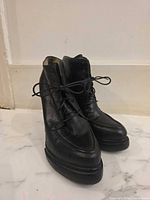 front/side view of both black leather ankle boots