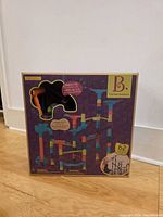 Front of boxed B. Toys Marble-palooza showing contents window and 62-piece count