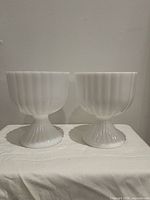Front view of both milk glass pedestal bowls