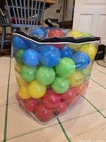 Full bag of plastic balls showing colours and clear vinyl bag