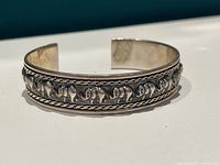 Top view showing raised elephant design across bracelet band