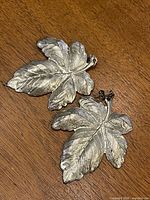 both earrings showing detailed leaf fronts