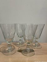 Four cut glass goblets front view
