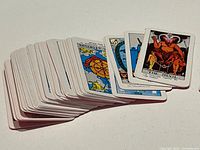 Stacked miniature tarot cards showing face artwork