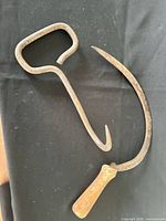 hay bale hook and sickle on black surface