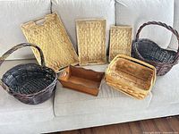 Group shot of all seven baskets and wooden caddy on sofa