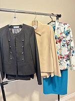 Three jackets and a dress on rack
