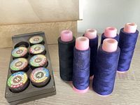 Tray holding eight stitch cams with coloured labels A-H