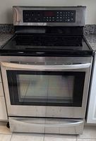 Front view of LG stainless steel induction range showing oven door, cooktop and drawer