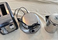 Overview of the three appliances: toaster, waffle maker, percolator