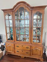 Front view of the china cabinet showing upper glass hutch and lower storage