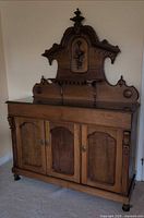 Full view of Victorian walnut chiffonier sideboard showing base cabinets, backboard, bun feet