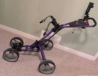 Full view of purple four-wheel golf cart
