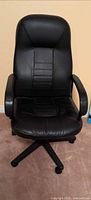 Front view of black faux leather adjustable office chair
