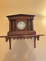 Front view of clock on shelf showing overall design