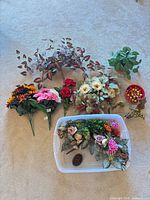 Group shot of all artificial arrangements, basket, and tote