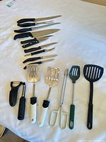 All utensils laid out showing knives, spatulas, tongs, peelers