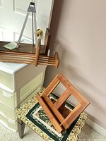 Lectern on upholstered bench next to shelf rack and metal easel visible