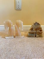 Both pairs of stone bookends side by side