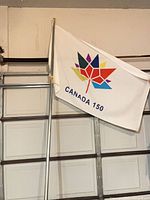 Flag on pole showing Canada 150 design