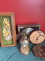 Group view of four clocks and papertole artwork