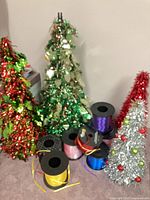 Group shot of four tinsel trees and ribbon rolls