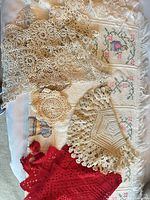 Group view of tablecloth and doilies showing colours and patterns