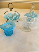 Group of four Fenton hobnail glass pieces: basket, ruffled dish, top hat vase, clear boot