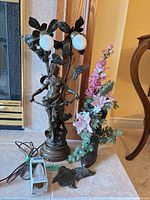 Lamp, boot planter, loose leaves, cord, spare bulb shown together
