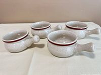 All four handled onion soup bowls on table