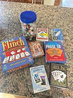 Group view showing all card games, decks, jar of marbles and packaged knife