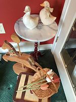 Overall lot showing marble table, two ceramic ducks, wooden horse, tulips, basket and box