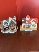 Front view of both miniature lighted buildings