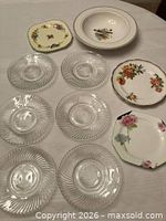 Group shot of six glass dessert plates, three assorted bread plates and bird-decorated bowl