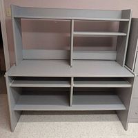 Full front view of grey desk with hutch and shelving