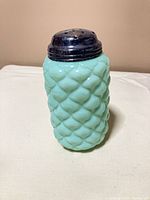 Full view of sugar shaker standing upright