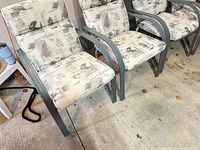 left two chairs closeup showing cushion pattern and paint wear