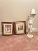 Group shot of both framed prints and ceramic statue