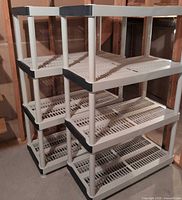 Two plastic shelving units side by side