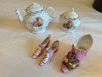 Group shot of creamer, sugar bowl, and three miniature shoes