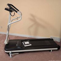 Full view of Pro-Form CrossWalk treadmill left side with manual and lubricant visible