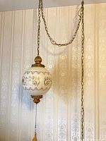 Full view of hanging lamp with chain and pull switch