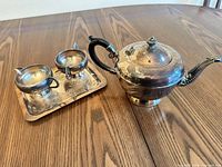 Full view of teapot, creamer, sugar bowl on tray