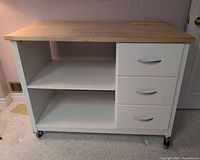 Front view showing butcher block top, open shelves, drawer side, casters